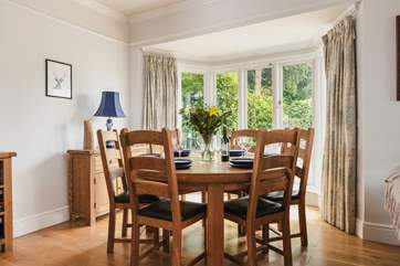 The dining-table has pride of place looking out over the terrace. The French windows open up to bring the outside in on a warm day.