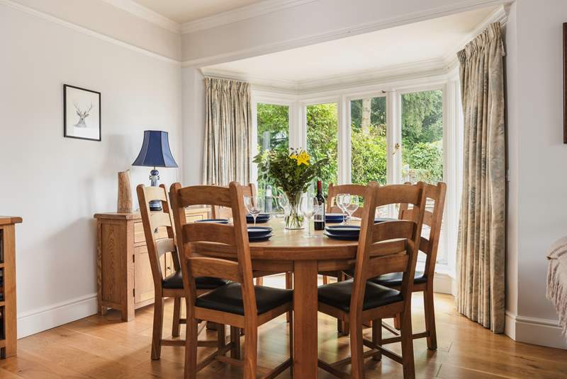 The dining-table has pride of place looking out over the terrace. The French windows open  up to bring the outside in on a warm day.