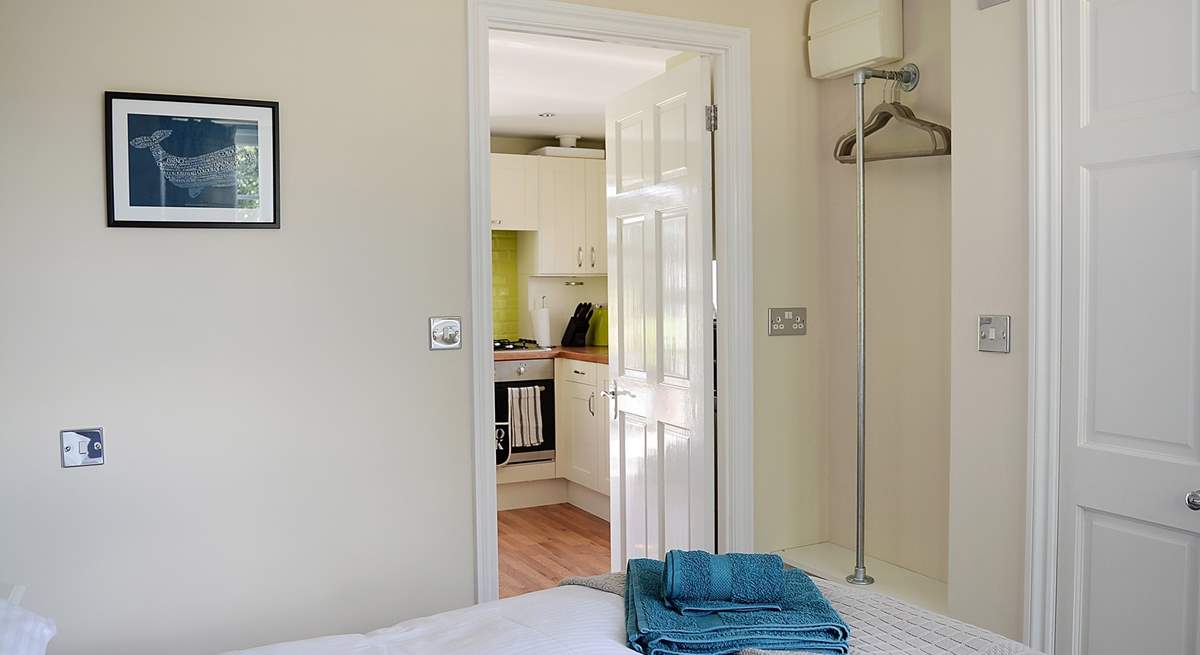 The kitchen leads into the bedroom.