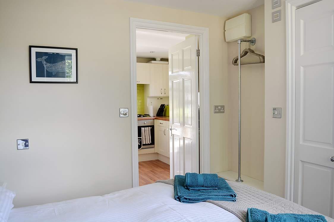 The kitchen leads into the bedroom.