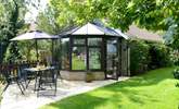 The conservatory looks out across the patio at the owner's garden. - Thumbnail Image