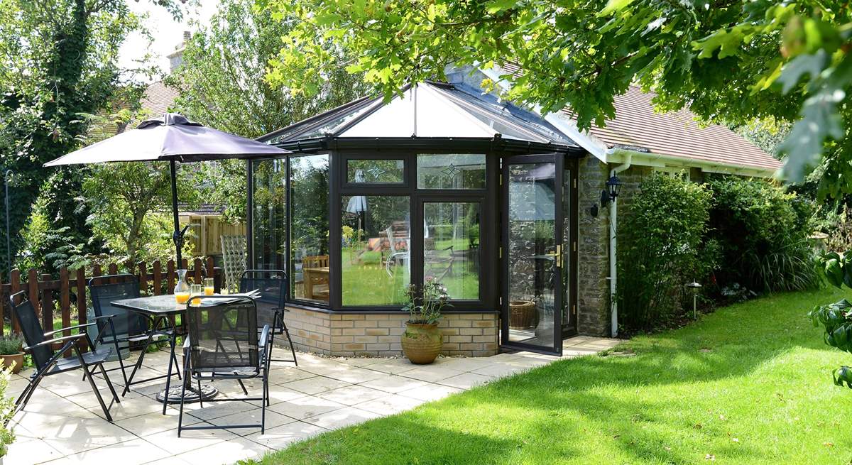 The conservatory looks out across the patio at the owner's garden.