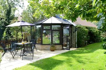The conservatory looks out across the patio at the owner's garden.