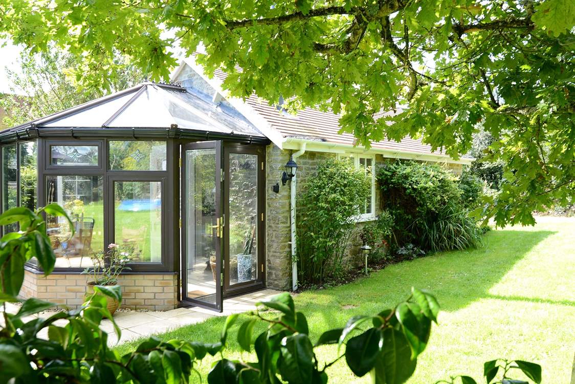 Owl's Nest Cottage nestles into the owner's mature garden.