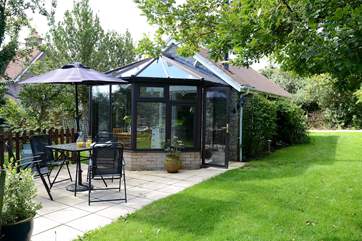 Owl's Nest Cottage is compact with a bright conservatory and pretty patio.