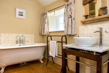 The stylish bathroom on the first floor has a gorgeous claw foot bath.