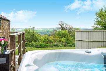 The hot tub is located to the side of the cottage, and takes full advantage of the stunning views.