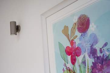 Pretty colours in the artwork echoes the colours in the soft furnishings.