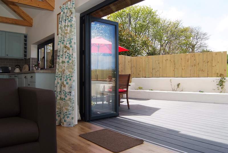 Bi-fold doors open out to the secluded deck.