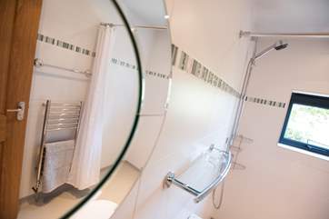 A heated towel rail keeps the shower-room snug.