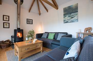 A modern wood-burner adds a focal point on cooler days.