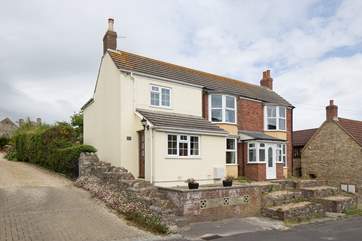 September Cottage is semi-detached in a quiet road; steps lead up from parking directly outside.