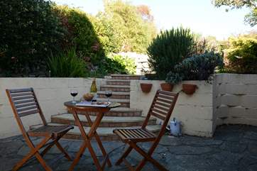 The patio is very sheltered and has views to the top of the back garden. Please supervise children on the steps.