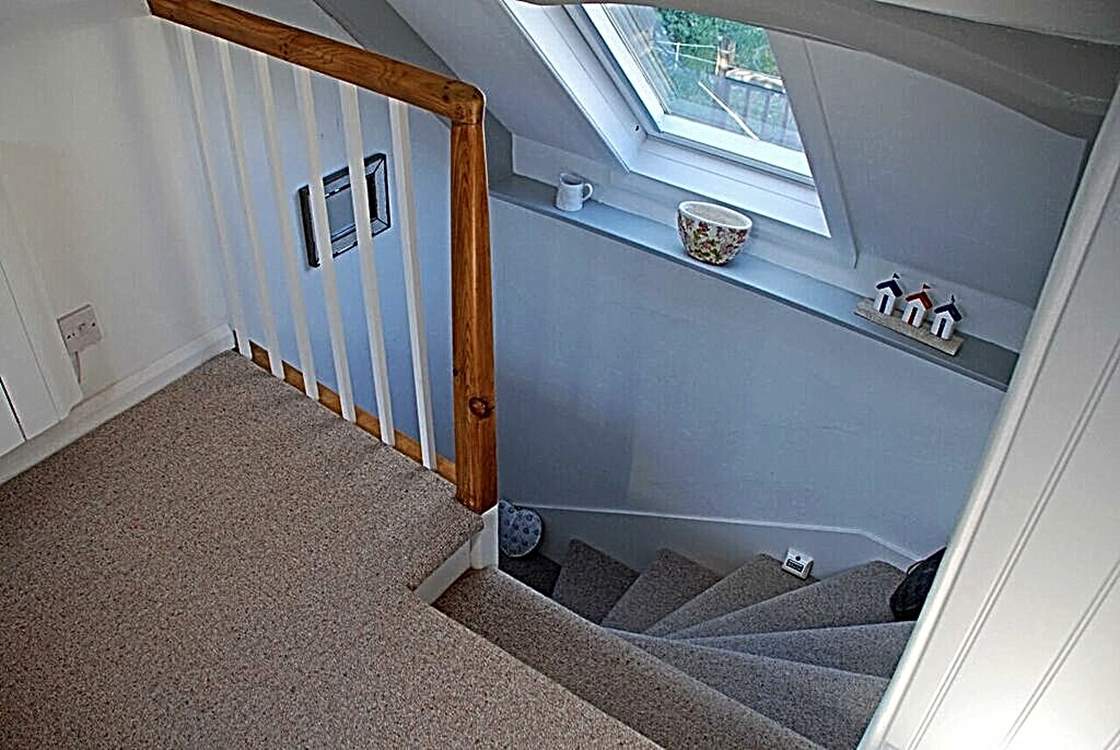 The stairs up to the top floor - watch your head on the low lintel.