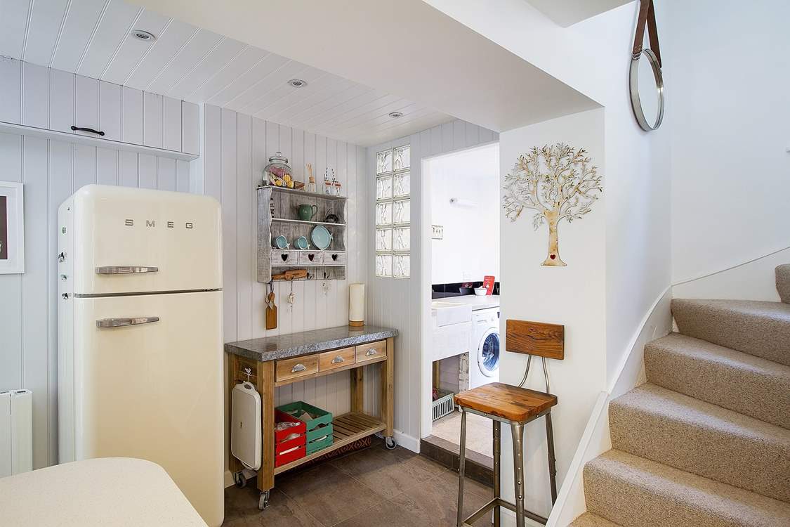 There is a utility-area leading off the kitchen and out to the back door.