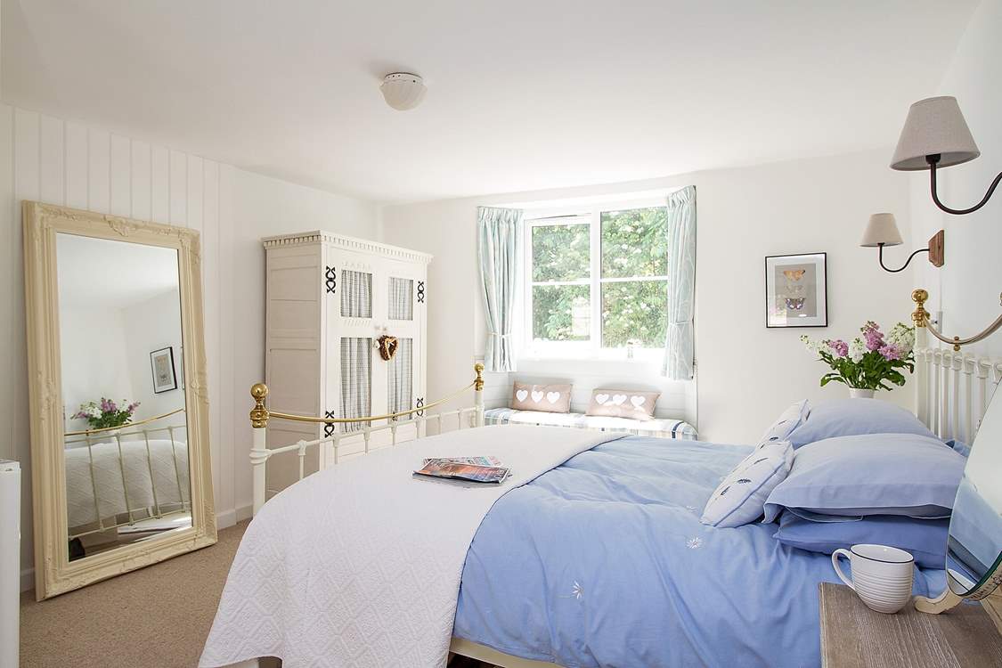 Bedroom 1 is furnished in soft blue and white.
