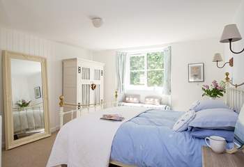 Bedroom 1 is furnished in soft blue and white.