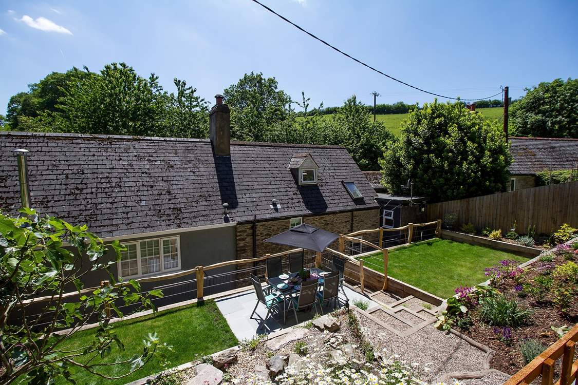 The pretty terraced garden at the back of the property - take care with children on the steps up and down.