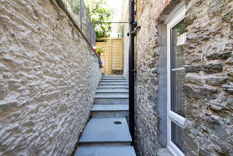 Uneven and different height steps lead from the back door to the terraced garden (take care with children).