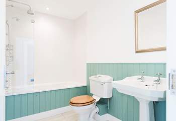 The beautiful bathroom with white fluffy towels and luxurious bath robes.