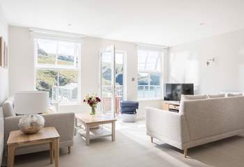 The light and spacious open plan living-room is flooded with light from the large windows and door leading out onto your private balcony.