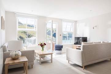 The light and spacious open plan living-room is flooded with light from the large windows and door leading out onto your private balcony.