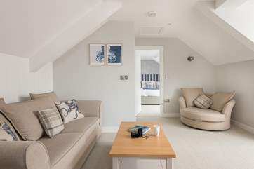 The sitting-room is beautifully and comfortably furnished and sits between the bedroom at one end of the apartment and the kitchen at the other.