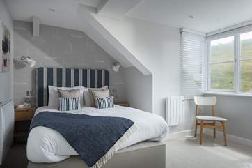 The gorgeous bedroom with king-size bed dressed with crisp cottons and comfy pillows and en suite shower-room.