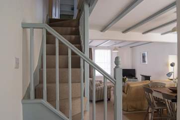 Steep cottage stairs lead up from the sitting-room.