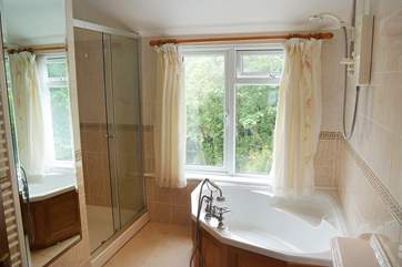 The very spacious bathroom has a corner bath, electric shower and large shower cubicle, something for everyone.