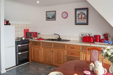The well-equipped kitchen is to one side of the open plan living-room.