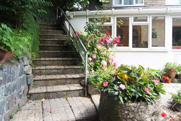 There are two flights of steps leading up to the front door with your parking space close by in front of the property.