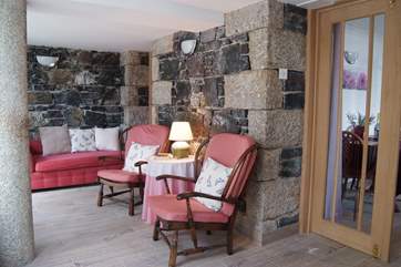 There is an additional sitting-area to the front with comfy chairs and a chaise longue, the exposed stonework gives this space real character.