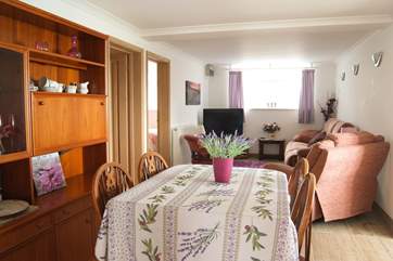 The sitting/dining-room has space to relax on the sofa and reclining chair at one end and the dining-area at the other.