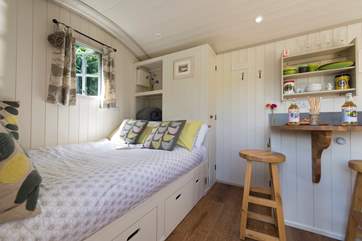 The comfortable bed has lovely linens.