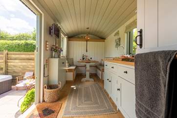The kitchen is fully fitted with a double hob and small fridge.
