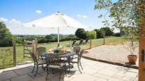 The Cow Shed offers space and tranquility. The patio is fully enclosed and beyond is the meadow, which is a wonderful space for you and your hound to enjoy.