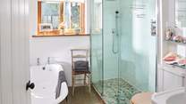 The downstairs bathroom has been beautifully designed, with a lovely deep bath as well as a walk-in shower.