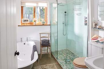 The downstairs bathroom has been beautifully designed, with a lovely deep bath as well as a walk-in shower.