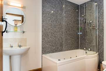 The en suite bathroom for Bedroom 1 has a wonderful jacuzzi bath.