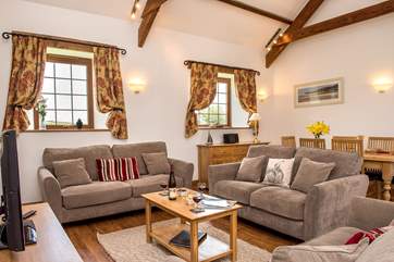 The open plan living/dining-room is beautifully furnished.