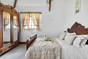 The antique French bedstead really adds a touch of romance to Bedroom One.