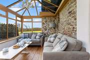 The conservatory leads off from the kitchen and can provide a quiet place to escape to.
