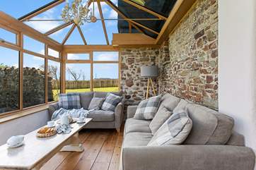 The conservatory leads off from the kitchen and can provide a quiet place to escape to.