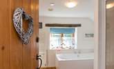 The bathroom leads off from the bedroom. - Thumbnail Image