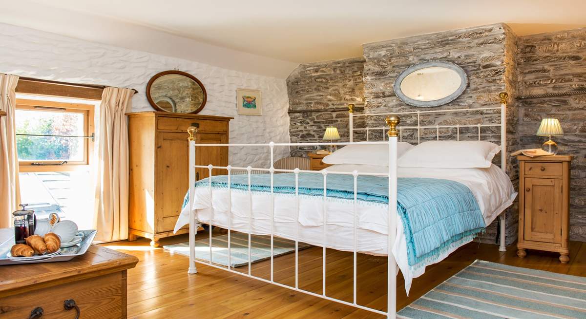 The bedroom is dual aspect with windows overlooking the garden and the front of the cottage.