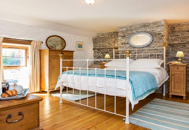The bedroom is dual aspect with windows overlooking the garden and the front of the cottage.