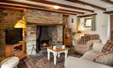 The sitting-room is snug and cosy and the wood-burner makes it an ideal retreat all year round. - Thumbnail Image