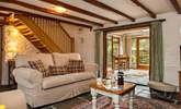 The cosy sitting-room leads out to the conservatory. - Thumbnail Image