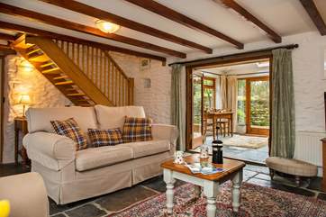 The cosy sitting-room leads out to the conservatory.